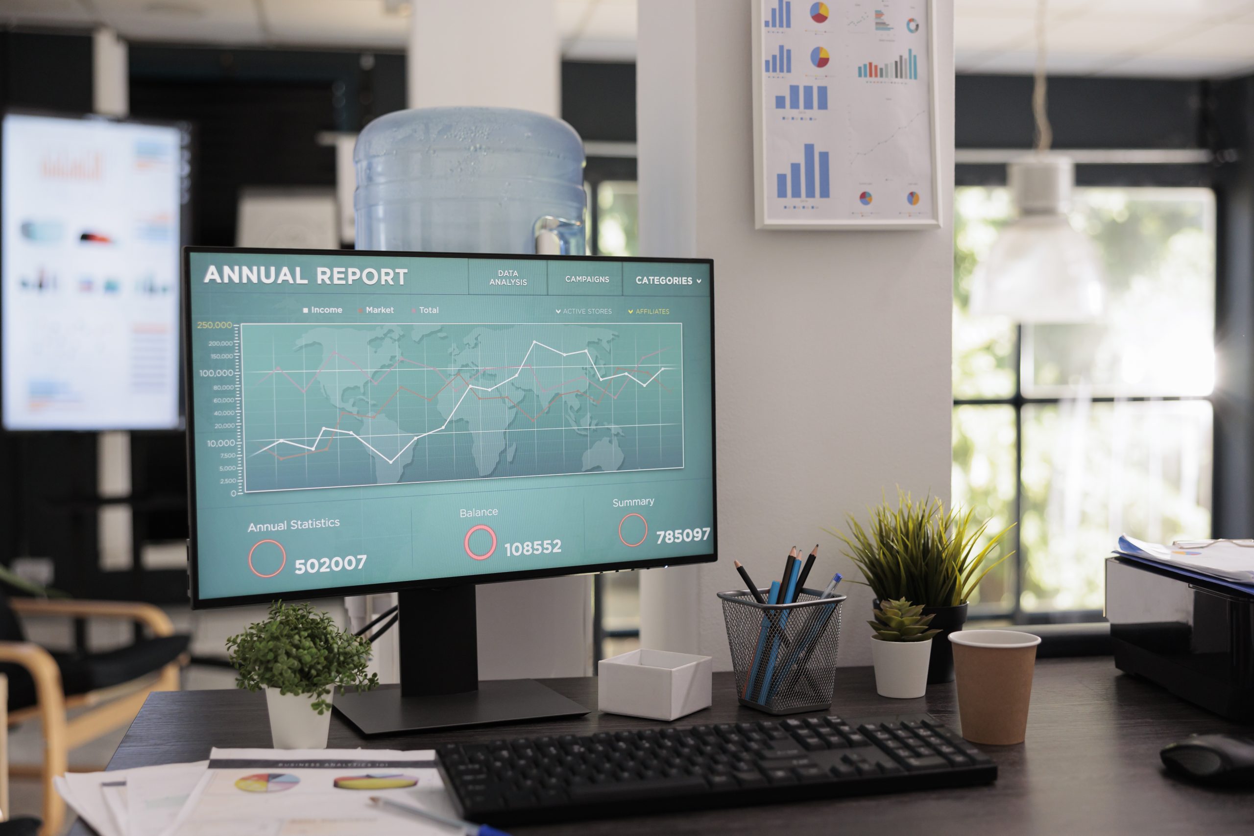 Front view of the computer screen with the company annual report and annual growth chart. No people in a business office with a monitor showing increase curve software.